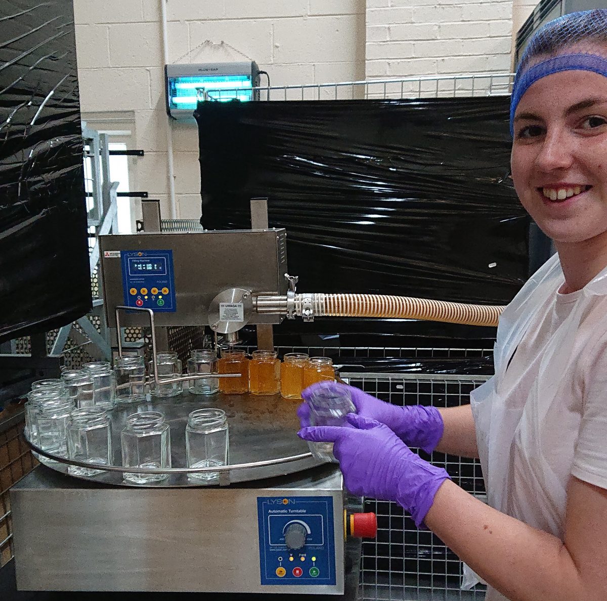 The first time learning to jar honey using the turntable and jarring machine