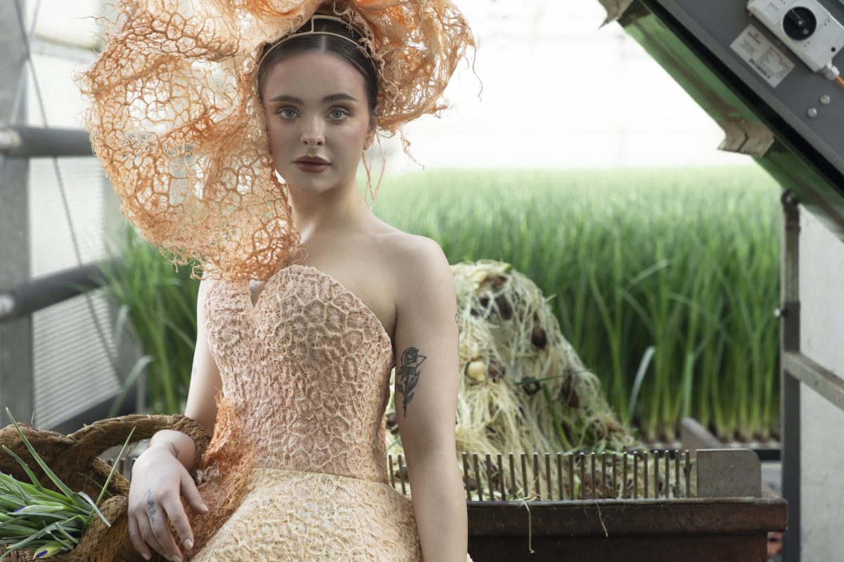 Fashion Bio couture - dress grown from grass root New, natural fibre grass root textile is used to grow dress and worn by a model on a farm setting