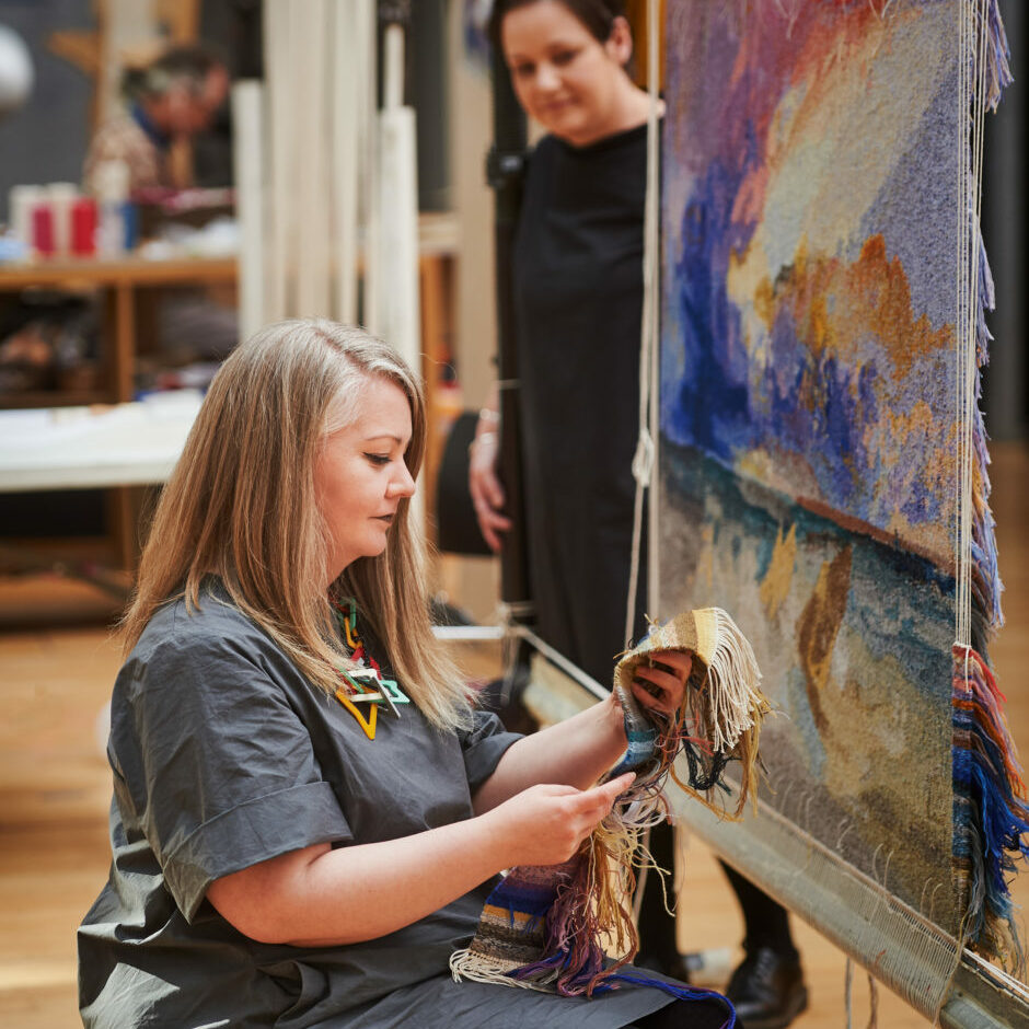 Dovecot Studios, Edinburgh, February 2021.
“The Art of Being An Apprentice”.
Dovecot Apprentice Elaine Wilson (foreground) with her JMW Turner Tapestry.
Pic free for first use relating to Dovecot Studios. Also pictured is Dovecot Studio Manager Naomi Robertson.
For press information please contact Susan McAteer, Marketing and Sales Manager, Dovecot Studios susanmcateer@dovecotstudios.com +44 (0) 131 550 3660
© Malcolm Cochrane Photography 
+44 (0)7971 835 065 
mail@malcolmcochrane.co.uk 
No syndication 
No reproduction without permission
